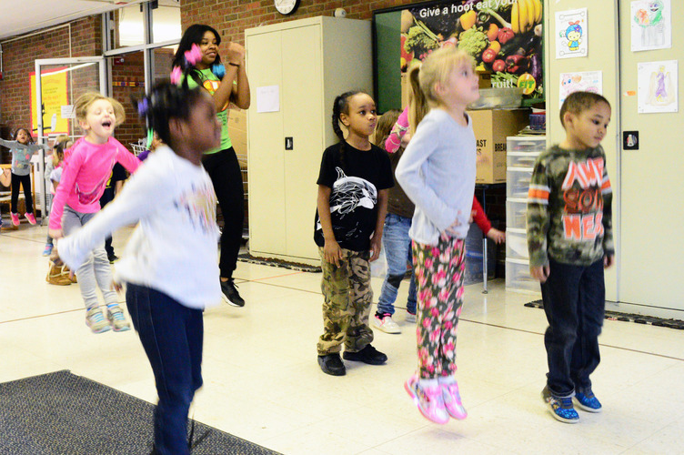 Emirrora Austin helps LaMora kindergarteners ”shake their sillies out.” Photo by Mark Wedel