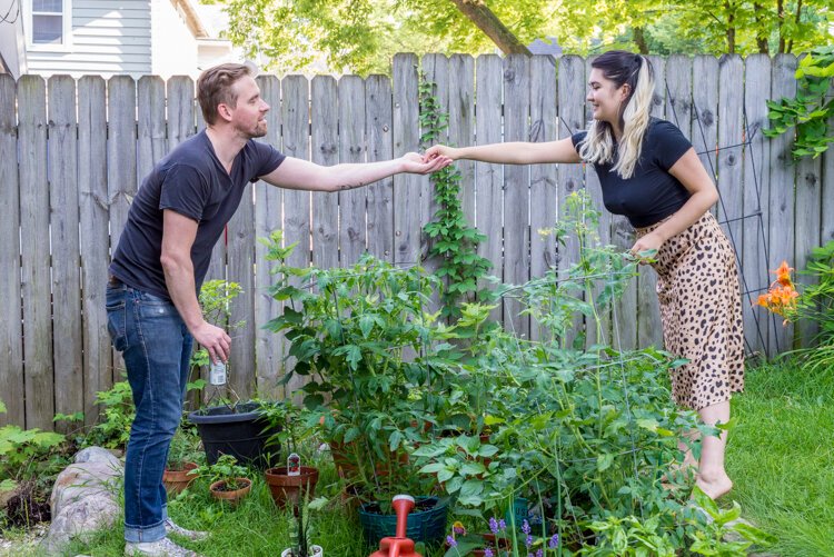  Chuck Lavelle and Olivia Mendoza share a special garden moment in their backyard oasis.