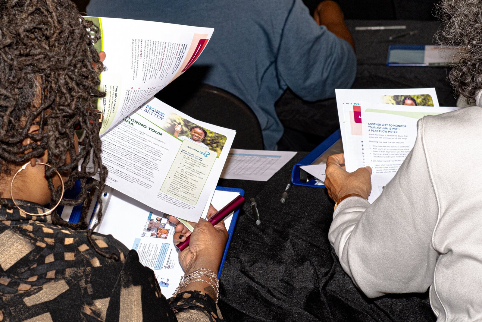 Guests viewing an informational poster about asthma