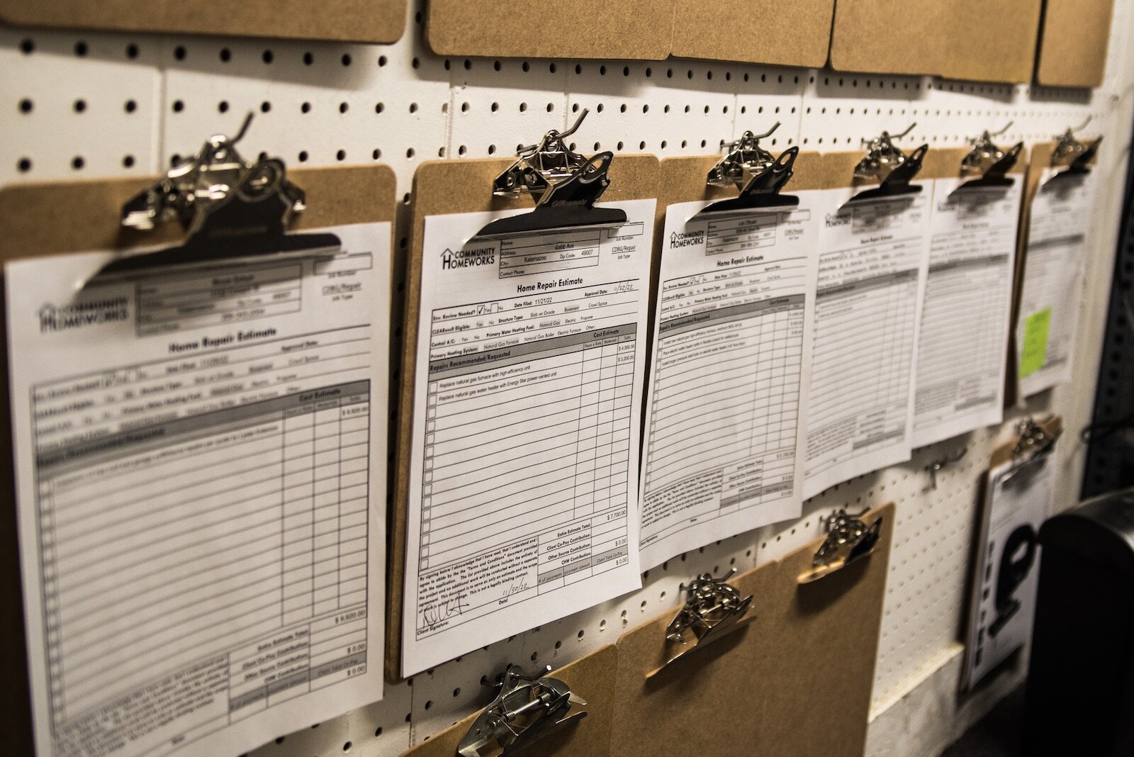 Clipboards with Community Homeworks jobs. One is for the installation of a new water heater and furnace -- as winter arrives, furnace replacements do, too.