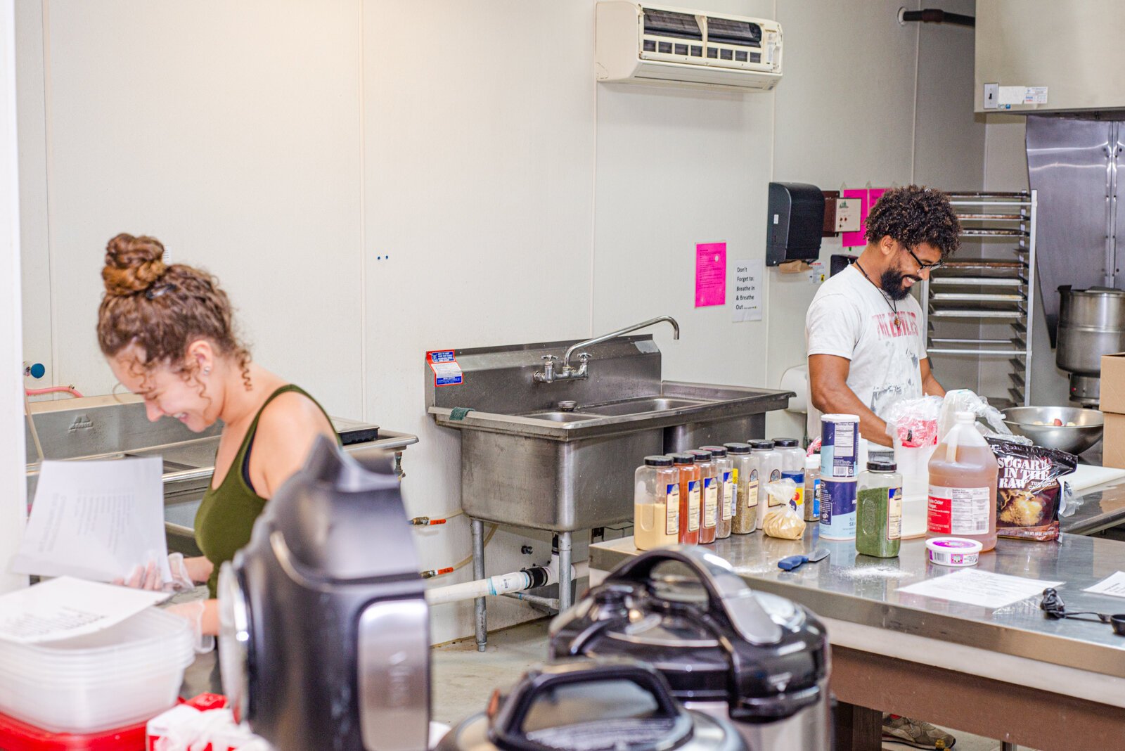 Nina Martinez works at Can-Do Kalamazoo with Derick Waters on food for customers of the Dirty Vegan.