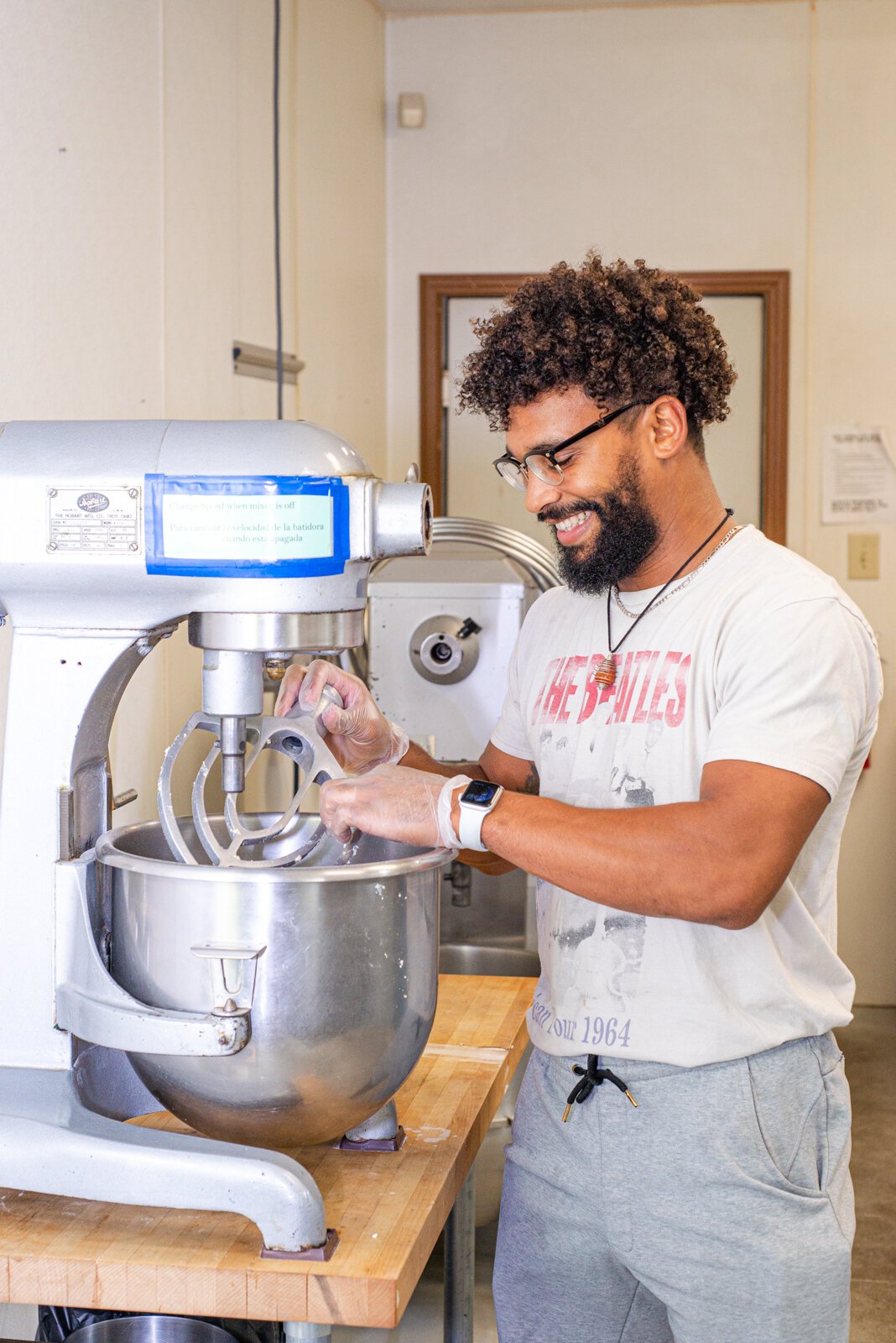 Derick Waters and Nina Martinez prepare garlic parm bites in the mixer.