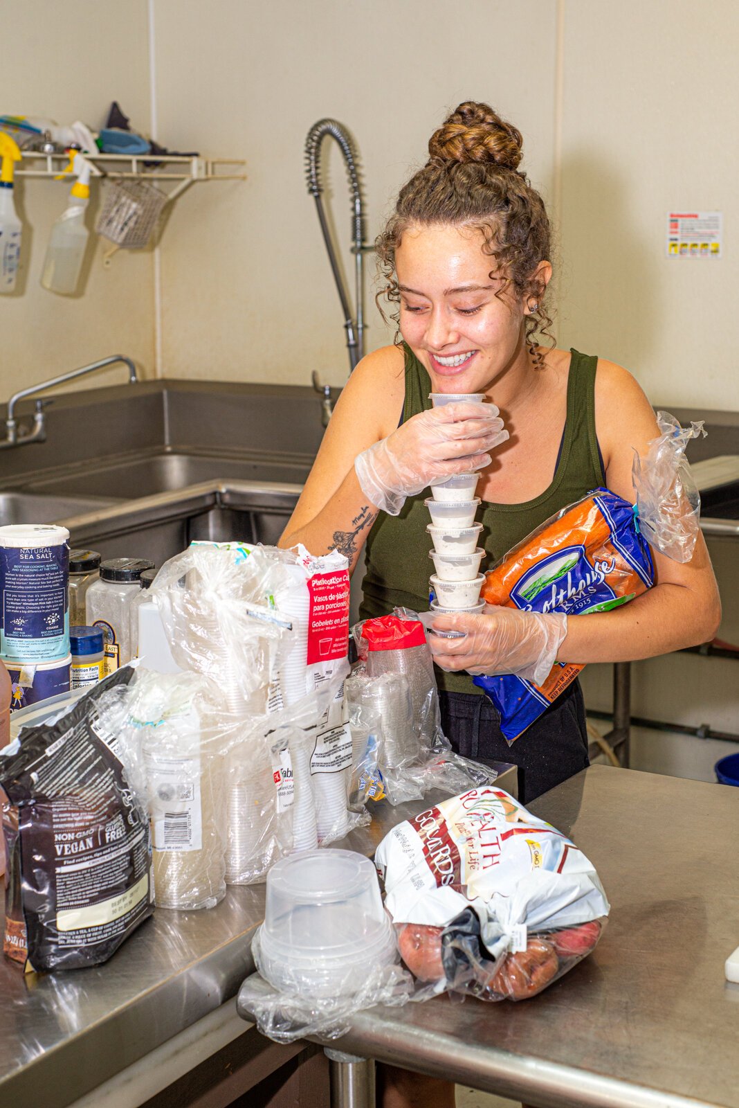 Nina Martinez works at Can-Do Kalamazoo with Derick Waters on food for customers of the Dirty Vegan.