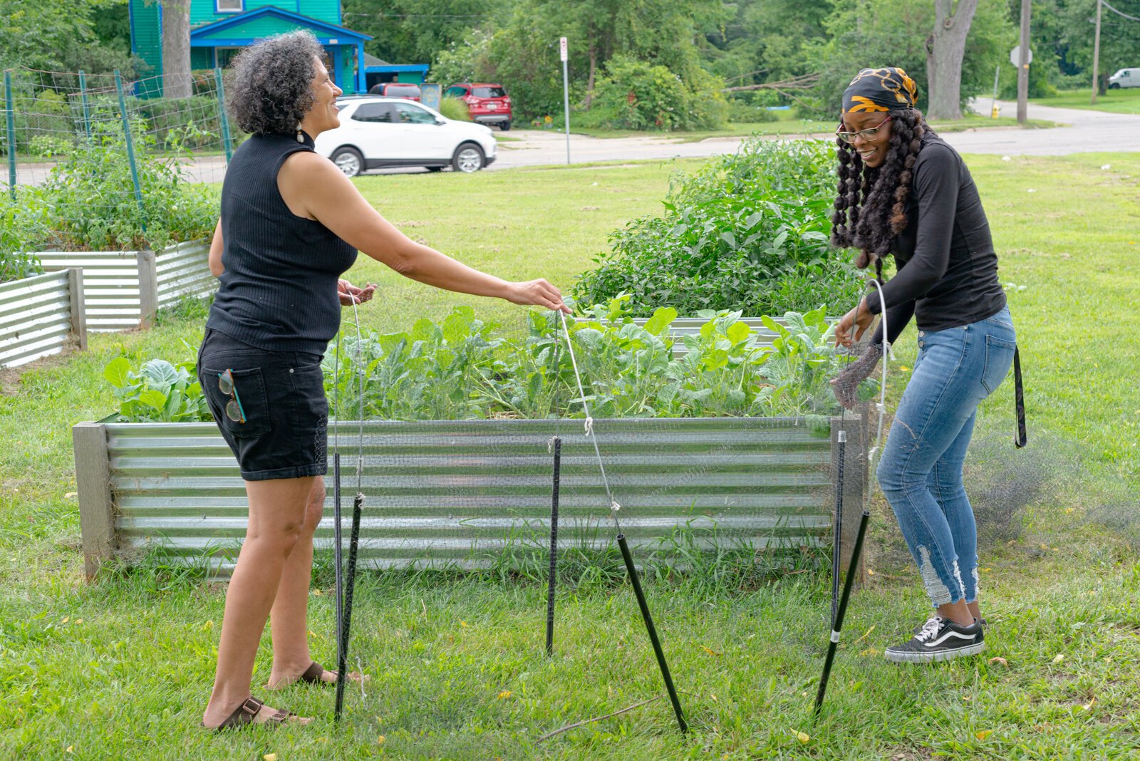 Dr. Michelle Johnson and Mary Crosby, lead gardener, work together in the community garden where they are making connections with the unhoused. 