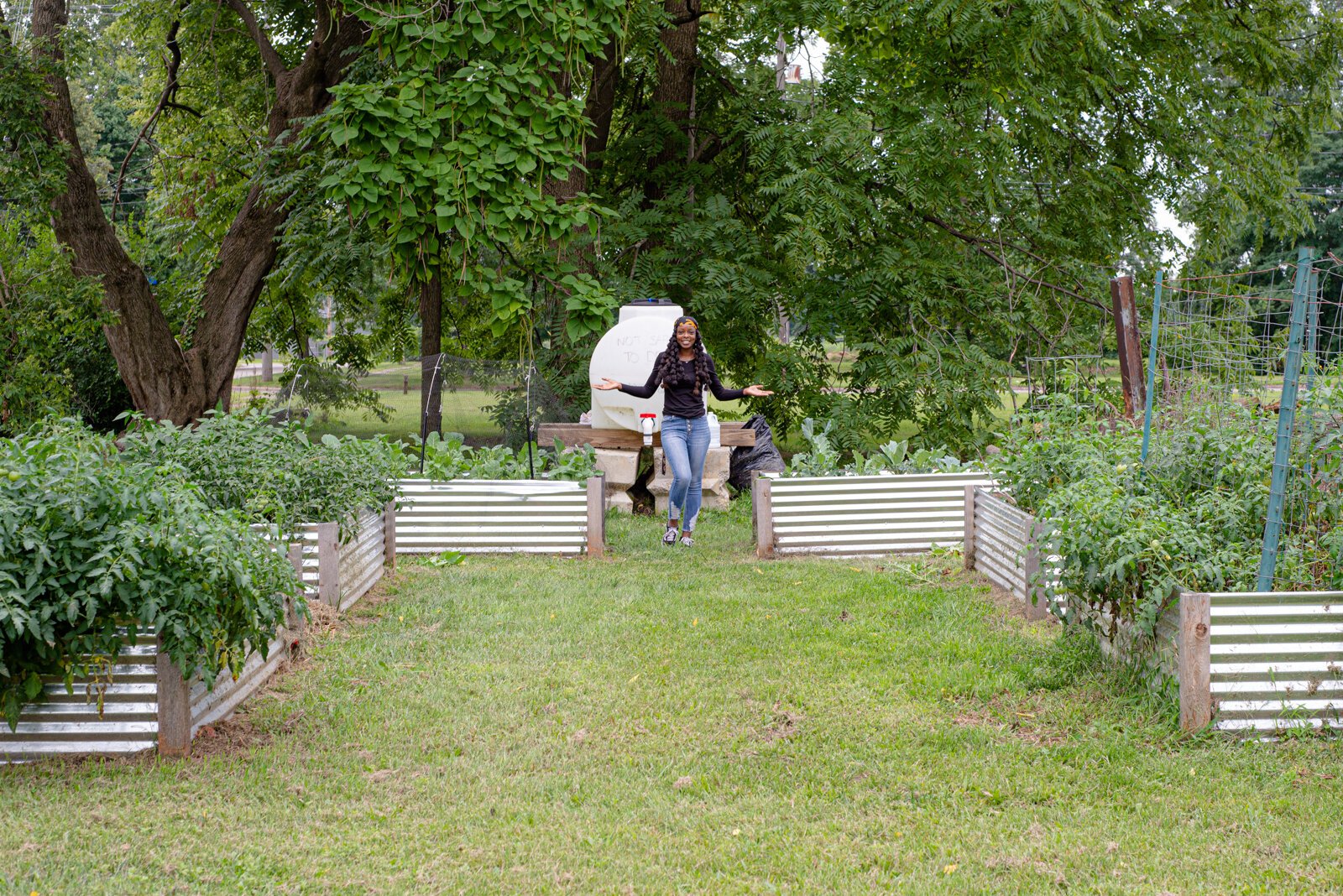 Mary Crosby, lead gardener, at the community garden shown here with the garden beds.