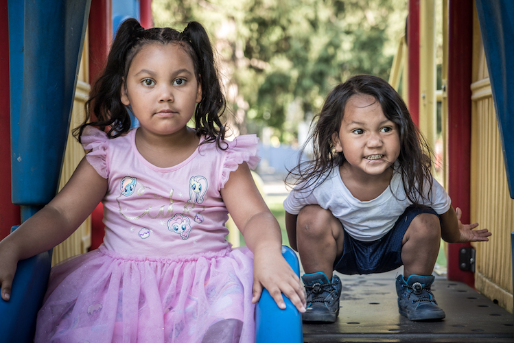 ymberlee and Jerome Castaneda head down the slide. Photo by Fran Dwight.