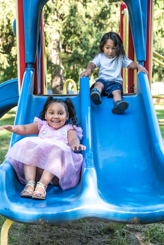 ymberlee and Jerome Castaneda head down the slide. Photo by Fran Dwight.