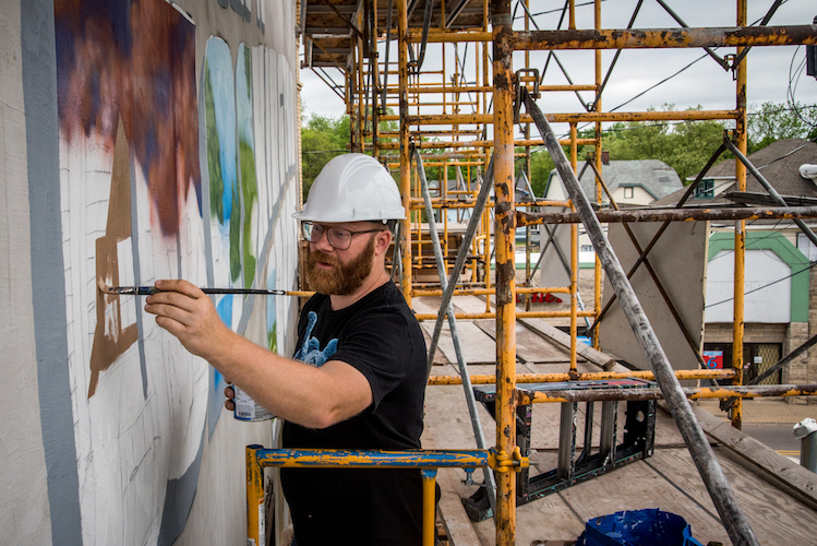 Patrick Hershberger at work on a new mural for the Edison neighborhood. Photo by Fran Dwight