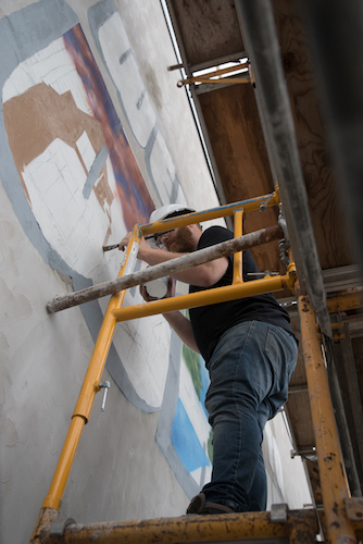 Patrick Hershberger at work on a new mural for the Edison neighborhood. Photo by Fran Dwight