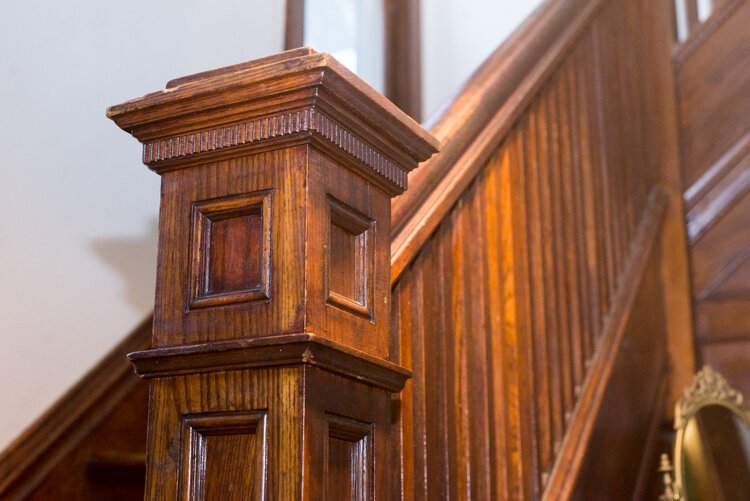 The period molding on the stairway bannister has been lovingly refinished in Sarah Ruggles’ historic home.