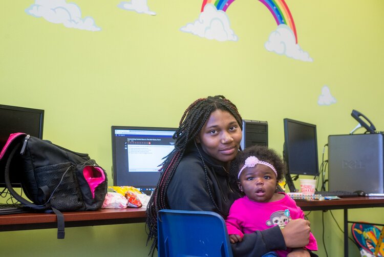 Young mothers often bring their babies to class at KCA, which seeks to remove any obstacles to earning a high school diploma. Here, Brianna Carouthers, is in a classroom with her daughter.
