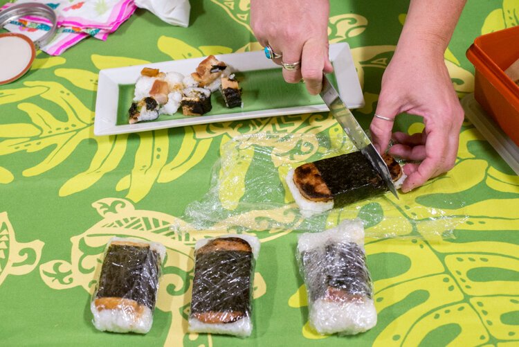 Parent Alison Parsons passes out musabi, a Hawaiian snack made of teriyaki sauteed Spam and seaweed--tastier than it sounds!