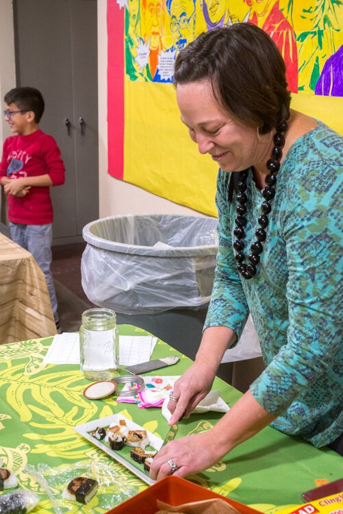 Parent Alison Parsons passes out musabi, a Hawaiian snack made of teriyaki sauteed Spam and seaweed--tastier than it sounds!