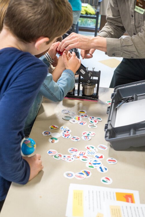 Steve Siebers, Washington Square Branch Lead Librarian, helps students with crafts at Taste of El Sol.