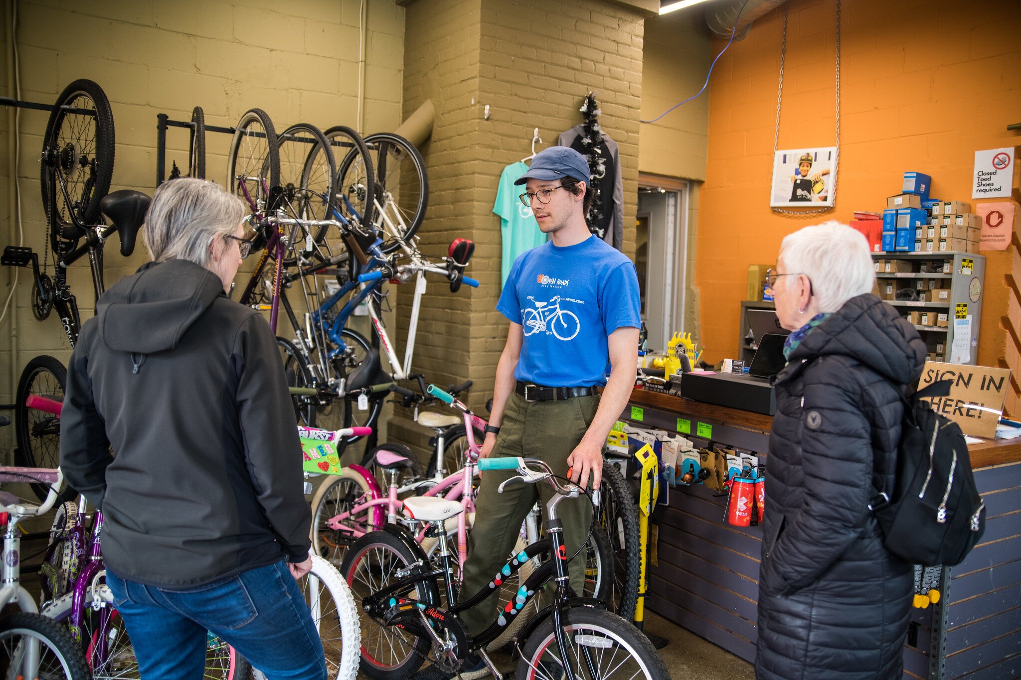 Ian Smith, Program Manager, in the shop at Open Roads with customers.