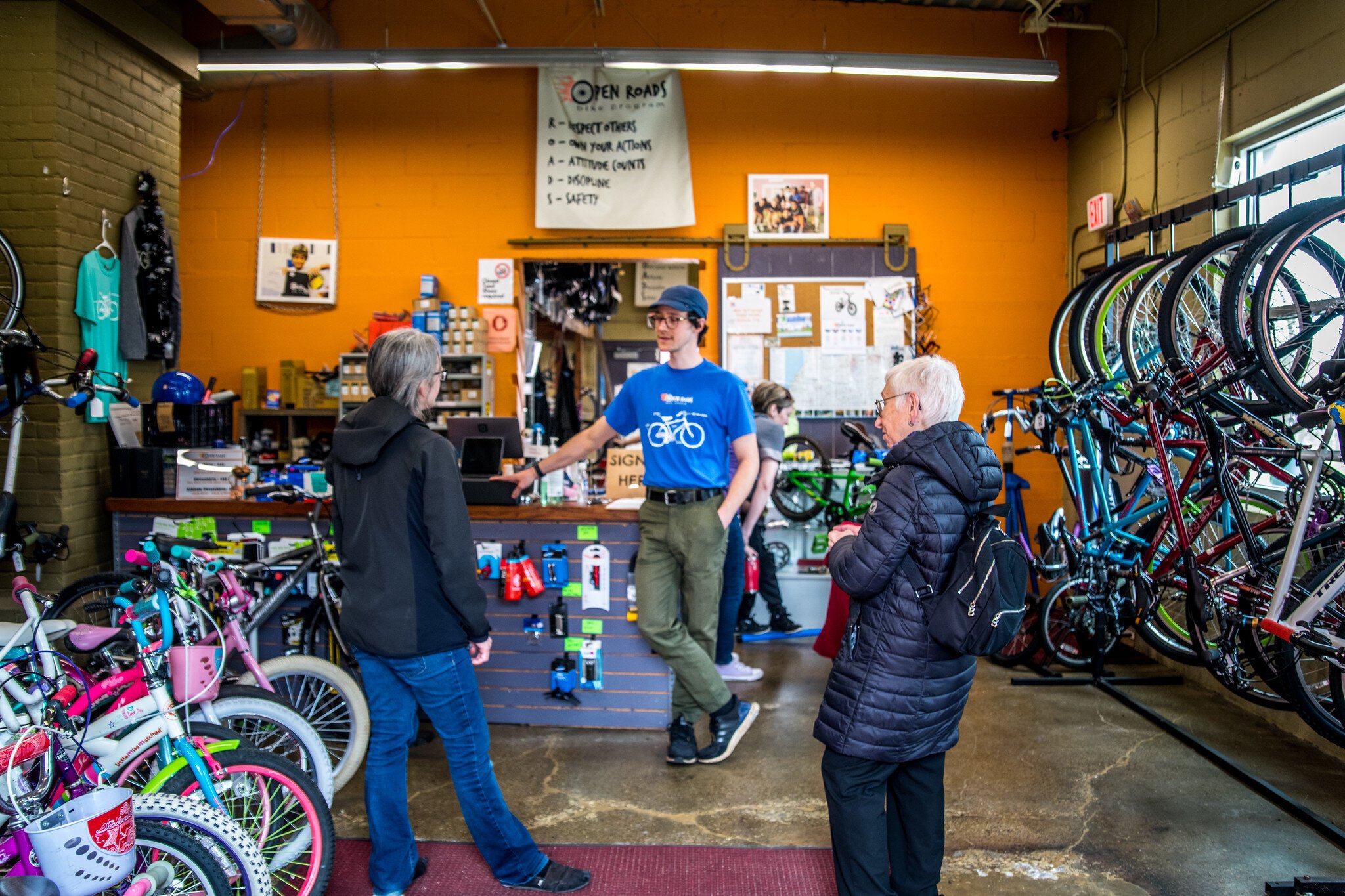 Ian Smith, Program Manager, in the shop at Open Roads with customers.