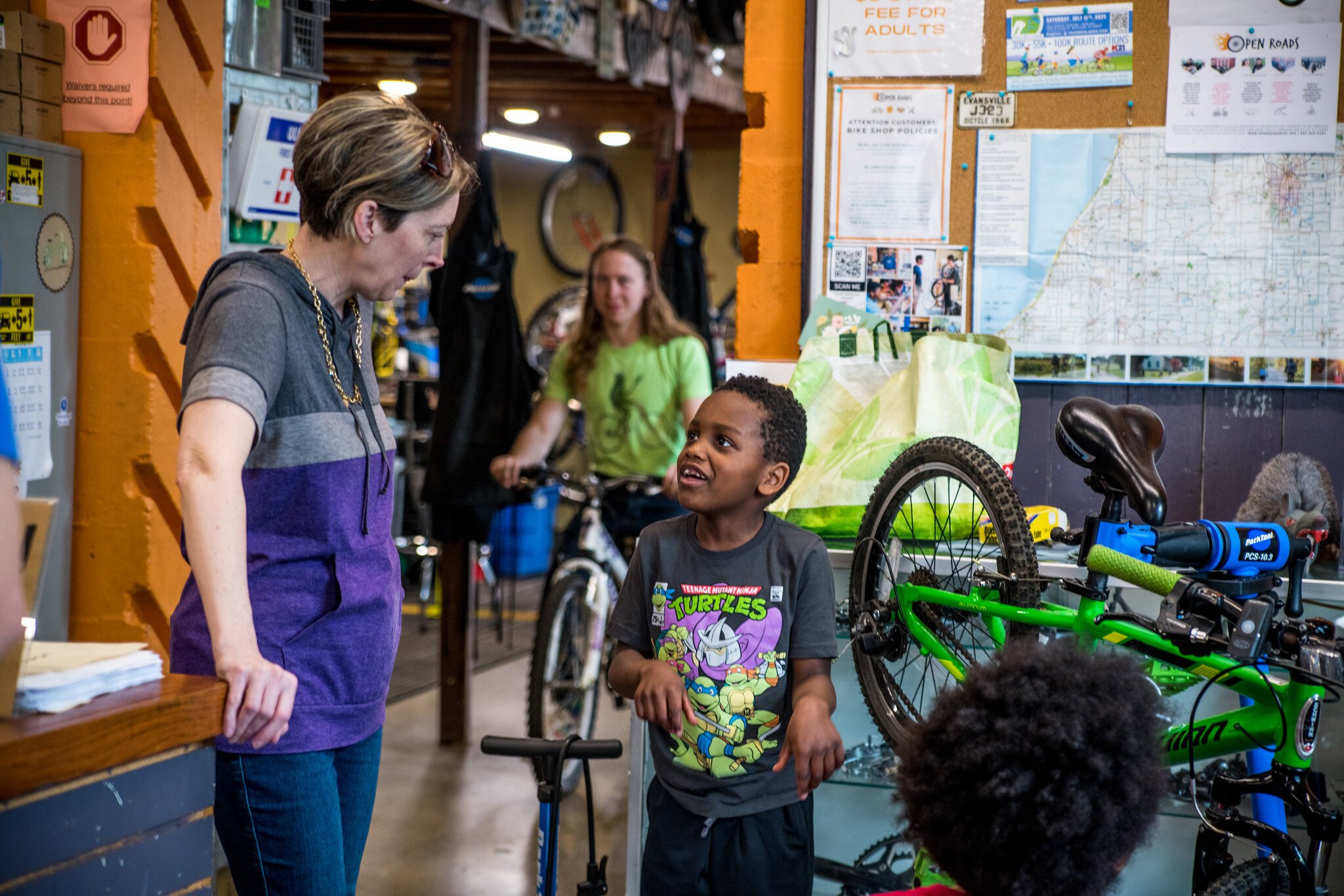 Ian Smith, Program Manager, talks to a young bicyclist.