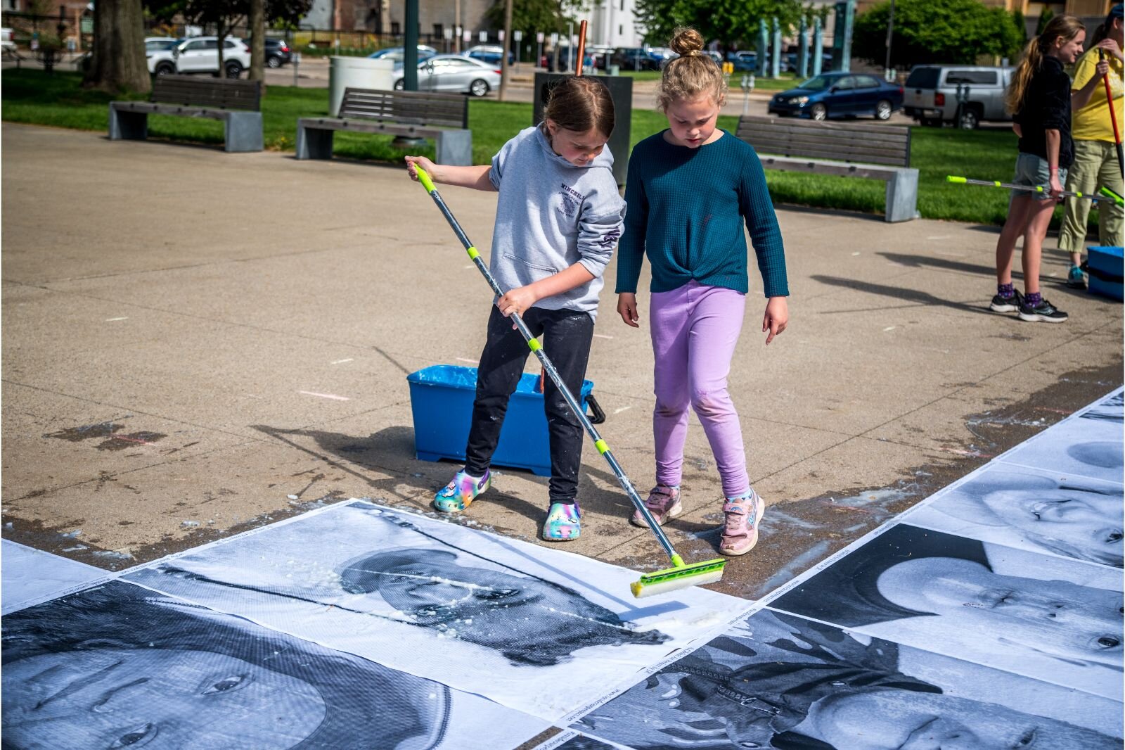 Students’ faces — smiling, laughing, thinking, frowning, squinting — are the focus of a display of almost 1,000 black and white portraits that will line the interior sidewalks of Bronson Park in an exhibition called “Inside Out: We Are Kalamazoo Arti
