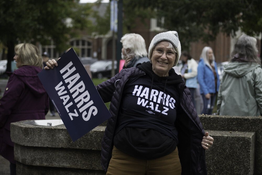 Susan Andress, a local photographer who has taken many photos for Southwest Michigan Second Wave over the years, proudly waves her sign.