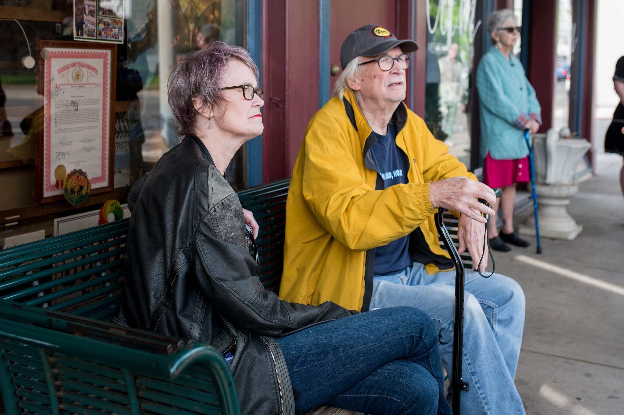 Darcy Wilkin and Mark Sahlgren sit outside Michigan News Agency.