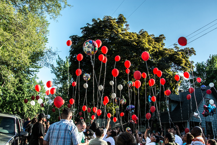 Neighbors come together to remember 13-year-old Michael Day killed in gang violence. Photo by Fran Dwight