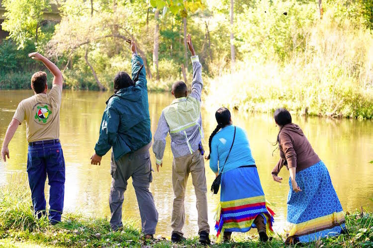  Tribal Members and guests toss their Wild Rice seed/mud balls into the Kalamazoo River in an effort to restock the water body with Wild Rice, during a 2016 Tribal Water Workshop.