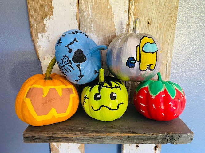 A grouping of pumpkins decorated by Ella Laupp. She sells them in the fall at her family's U-pick flower farm. In addition to flowers, the family also grows pumpkins and gourds that are sold in the fall.