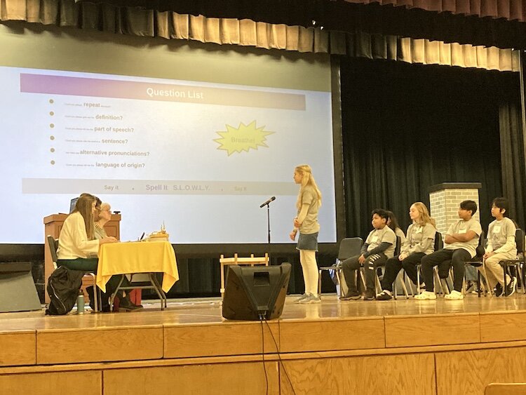 Emily Demlow, an 8th grader at Lakeview Middle School, takes her turn at the microphone during her school's Championship Spelling Bee.