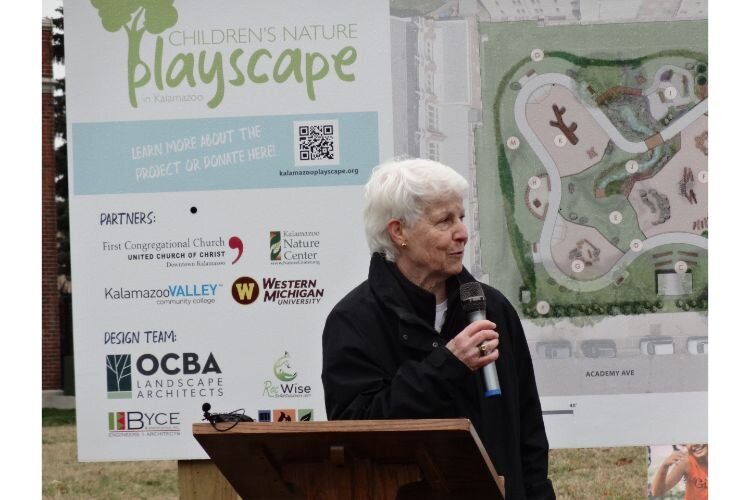 Jody Brylinsky, Children’s Nature Playscape on Bronson Park Steering Committee chair, addresses those gathered to celebrate the Playscape groundbreaking.