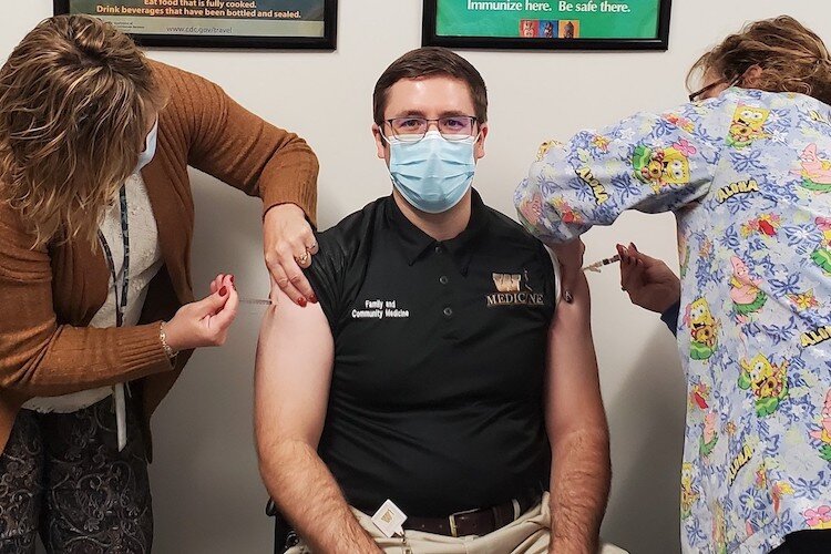 Dr. William Nettleton, Medical Director of Kalamazoo County Health and Community Services; Medical Director of Calhoun County Public Health Department gets vaccinations in both arms.