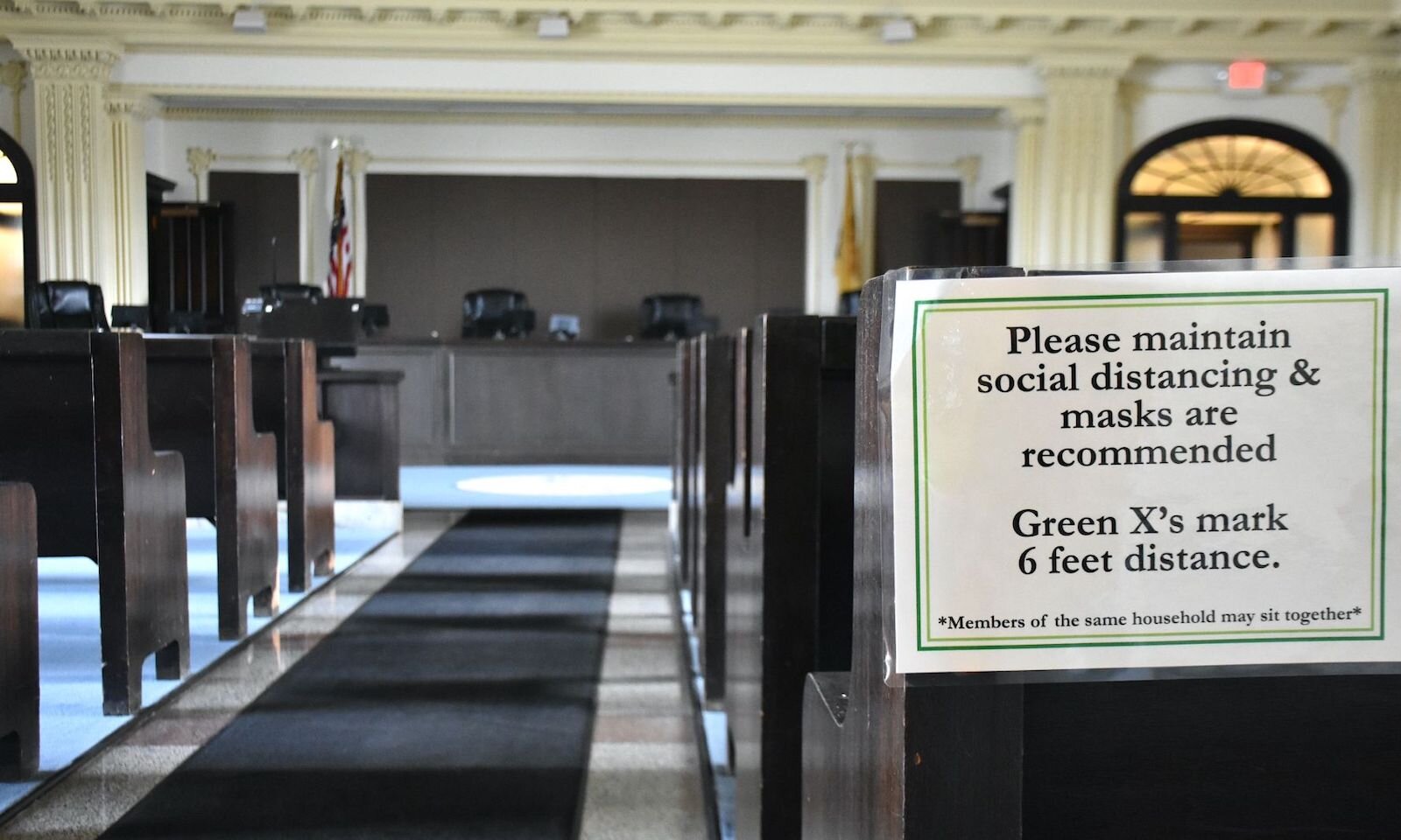A sign indicating social distancing and masks inside the City of Battle Creek’s city commission chambers.