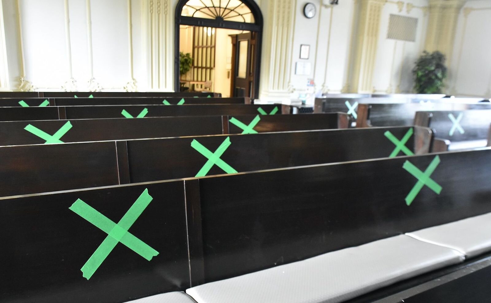 Green X’s are placed six-feet apart inside the City of Battle Creek’s City Commission chambers.