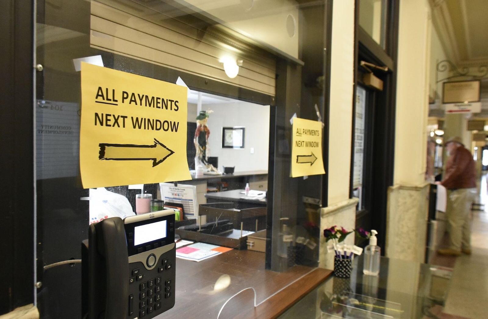 Plexiglass separates employees and members of the public making payments at Battle Creek’s City Hall.