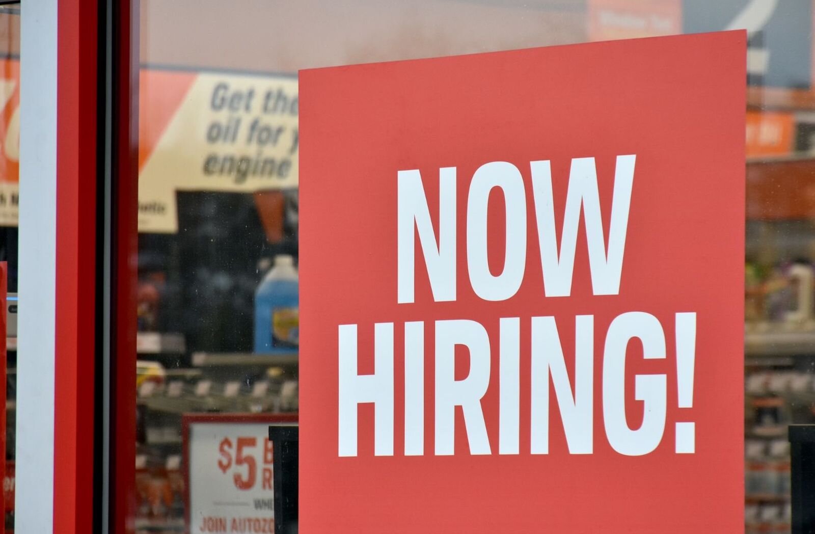 A now hiring sign at AutoZone on Beckley Road.