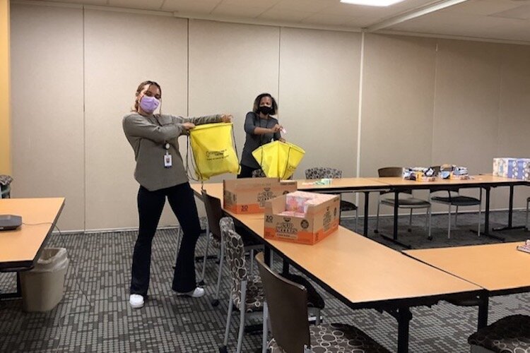 Family Health Center staff pack exam survival kits for Seita Scholars at WMU Center for Fostering Success.