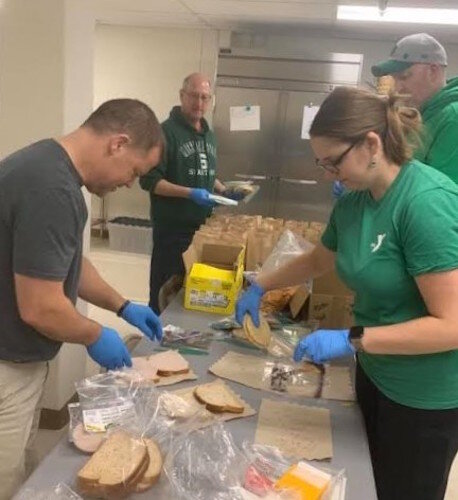Kalamazoo Y staff is shown preparing meals recently in the kitchen of the Maple Street location. From left they are: Don Seibert, Jim Migliaccio, Bobby Shea and Pete Jameyson.