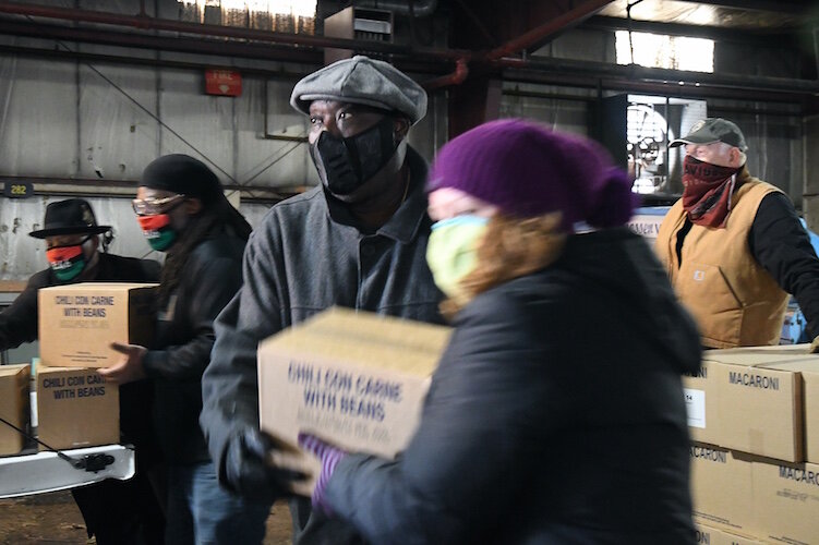 On Wednesday morning volunteers from churches throughout Battle Creek, including the Church of Jesus Christ of Latter-Day Saints, New Level Sports Ministries, unloaded and stacked a truckload of donated food for distribution over the coming.