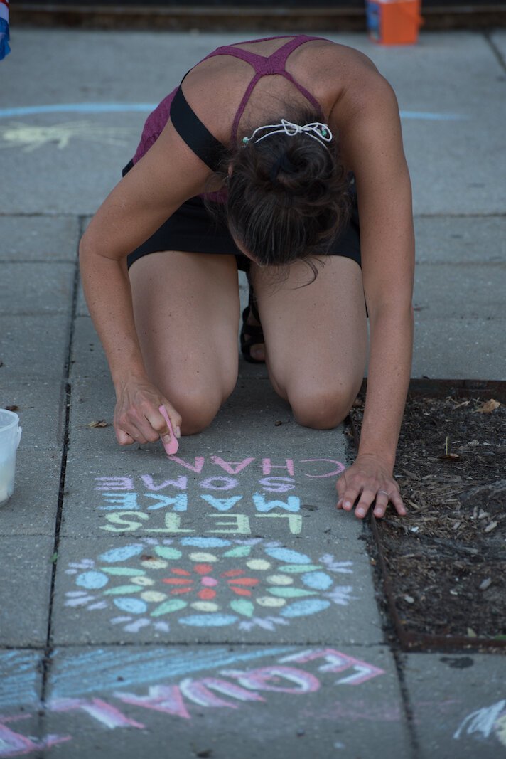 Let's make some change is the message of this chalk artists at the festivities celebrating the painting of the the Black Lives Matter mural on Rose Street, between Lovell and South streets on Friday afternoon.