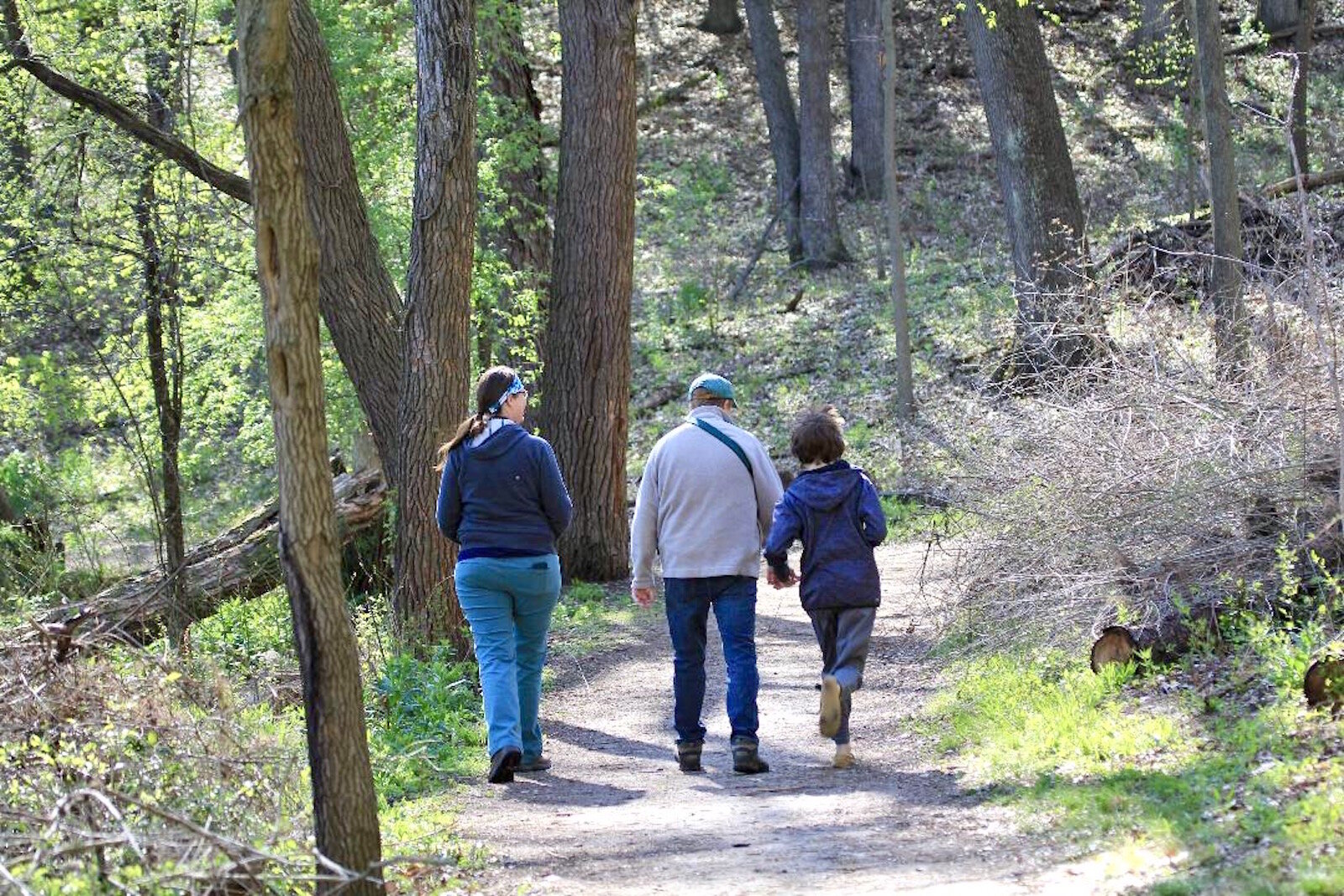 Erin Fuller takes a walk through the Kleinstuck Preserve with her husband Nate and their son Theo.