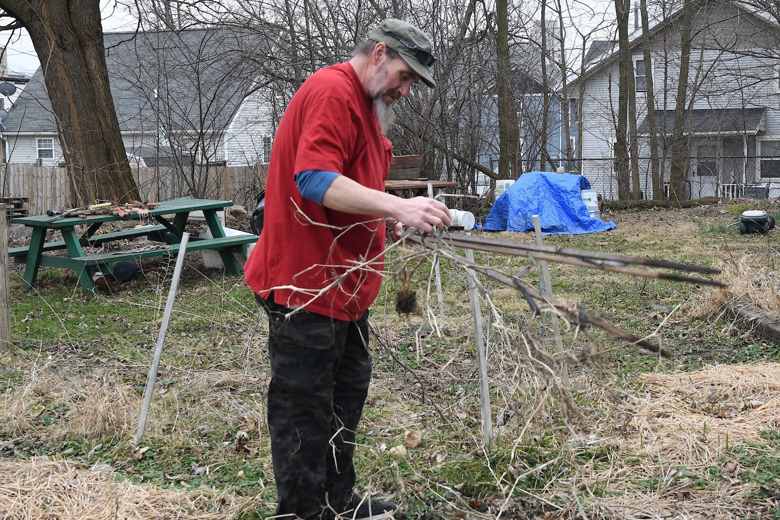 Thomas Hart cleans up refuse at the Fremont Garden.