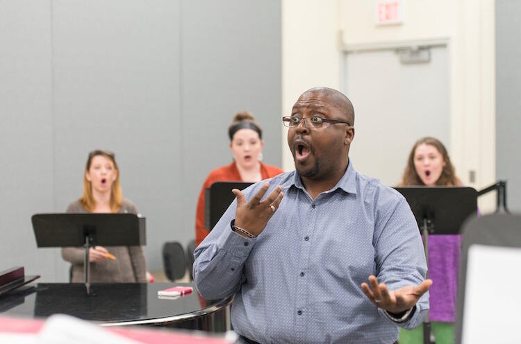 Dr. Gerald Case-Blanchard and choir in rehearsal.