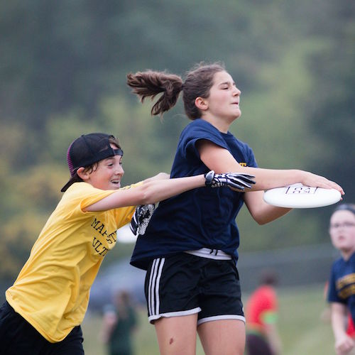 Haniya Frayer catches disc, while Owen Quayle defends. Photo by Kimberly Moss