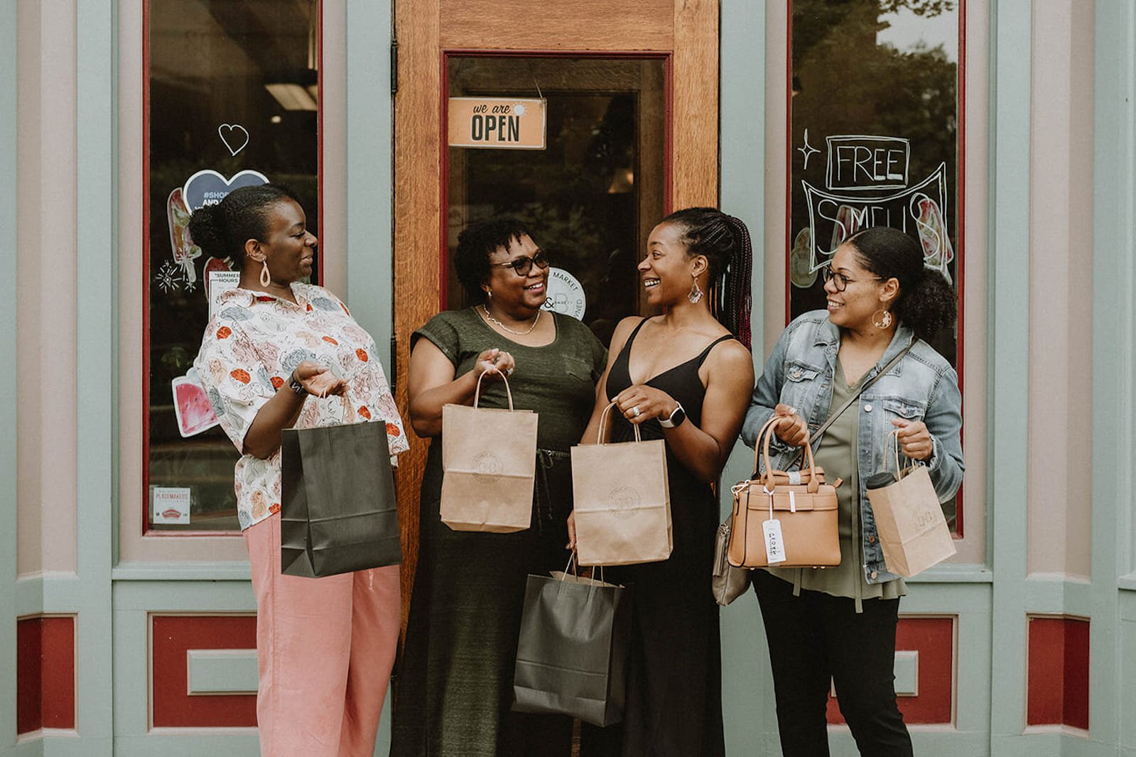 Happy shoppers with bags filled with their purchases from Bread and Basket are seen in front of the shop located at 38 East Michigan Avenue in downtown Battle Creek.