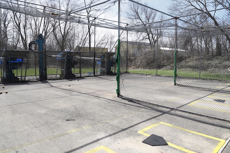 Batting cages offering fast baseball and softball pitches.