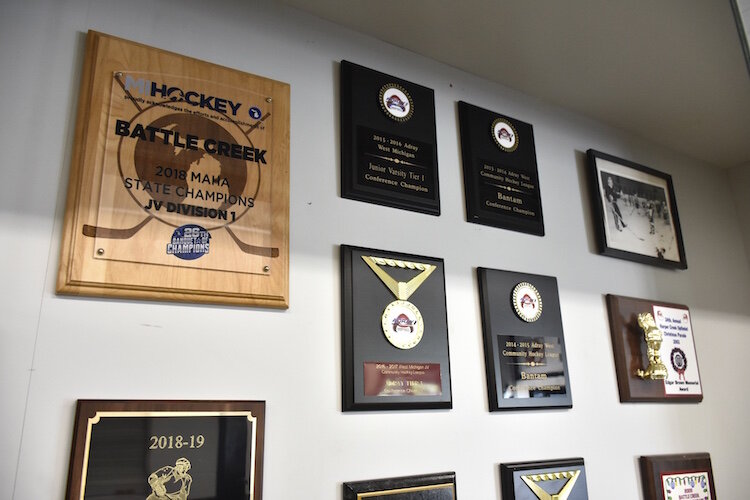 Some of the plaques in the trophy case on the wall at The Rink