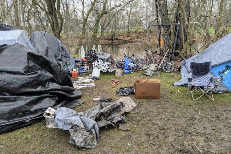 The Kalamazoo Coalition for the Homeless estimates there are five large "camps" of unhoused people in the area. They are loose clusters of homeless people who have pitched tents, tarps, or pallets near one another, Rabe says.