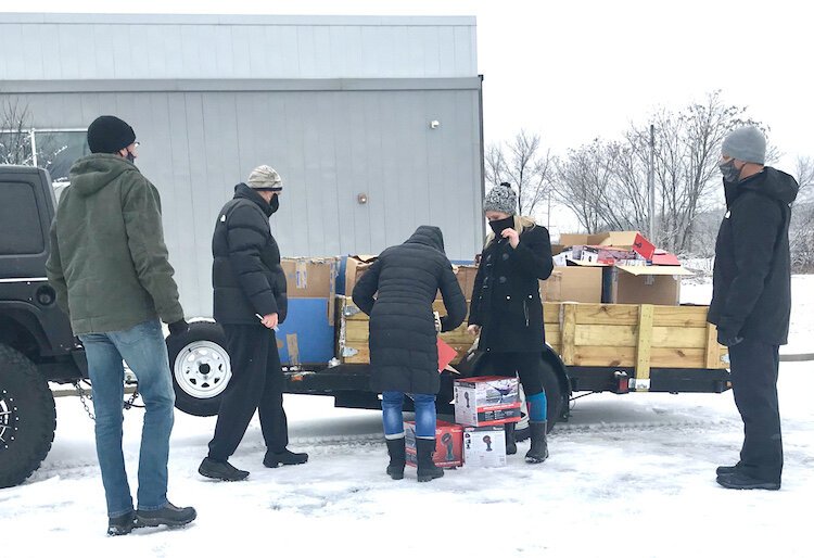 Coalition members gather on a recent Saturday to prepare to hand out portable propane heaters to people at homeless encampments in downtown Kalamazoo.