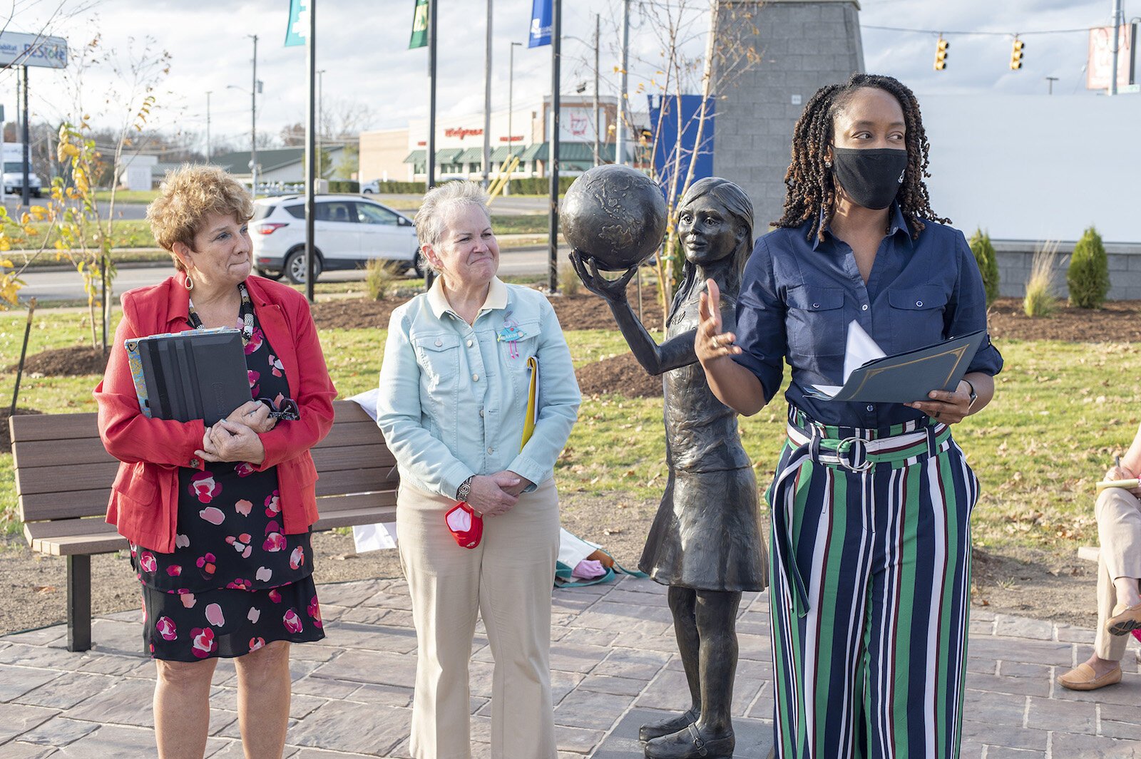 From left, Kay Calley-Martin and Kathy Shaw, co-chairs of the American Association of University Battle Creek Legacy Centennial Community Project Fund with Kellogg Community College President Dr. Adrien L. Bennings, unveil the statue, “Hope.”