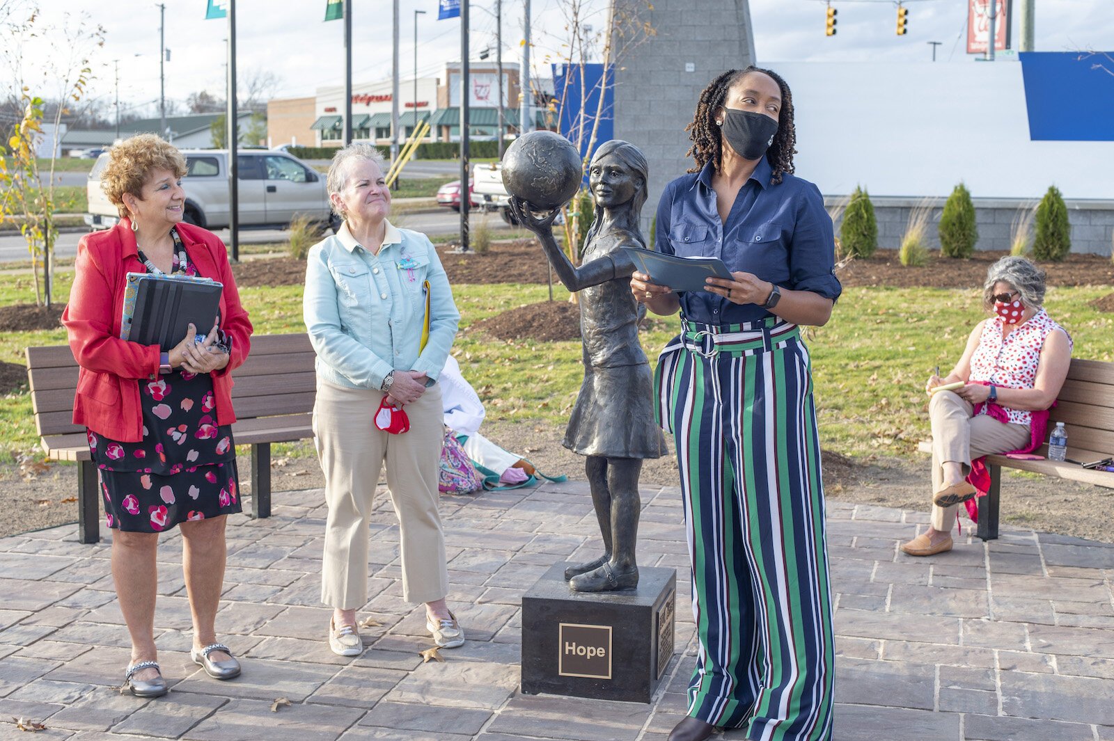 From left, Kay Calley-Martin and Kathy Shaw, co-chairs of the American Association of University Battle Creek Legacy Centennial Community Project Fund with Kellogg Community College President Dr. Adrien L. Bennings, unveil the statue, “Hope.”