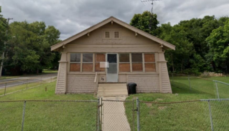 (Picture of an abandoned house on N. Wood St., on the corner of a lively neighborhood.